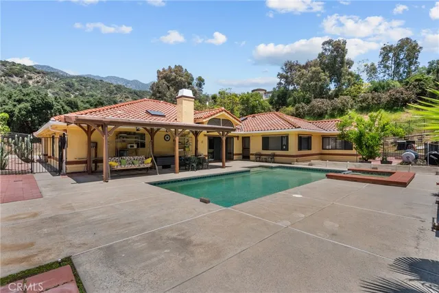 a view of a patio with a table and chairs with wooden fence