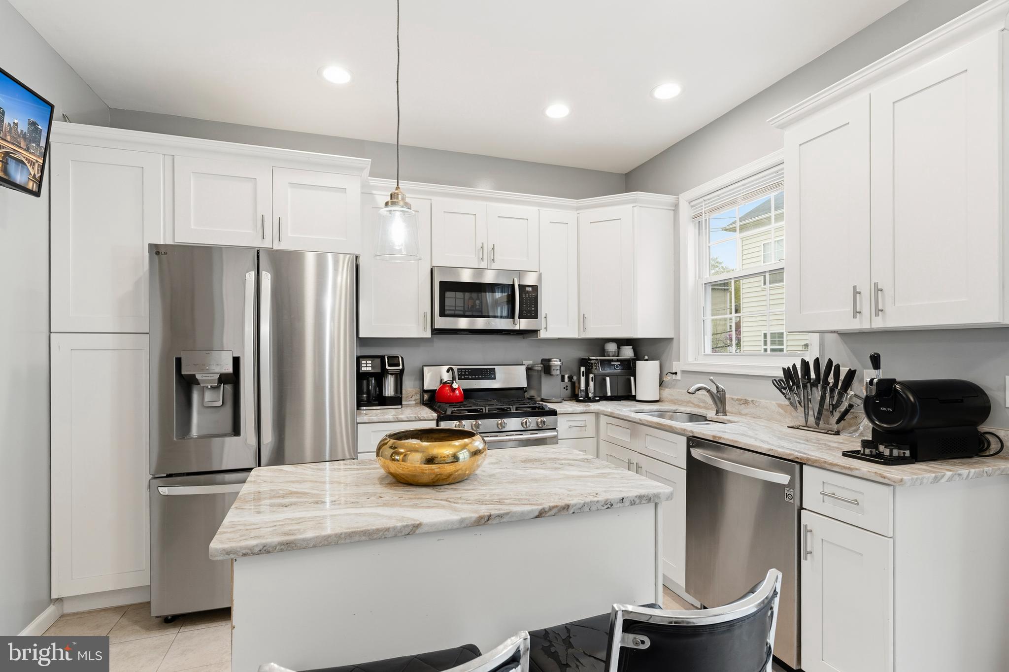 4285 South Capitol Street Southwest Washington, DC 20032 - Photo 12 of 24 a kitchen with a refrigerator a stove a microwave and cabinets