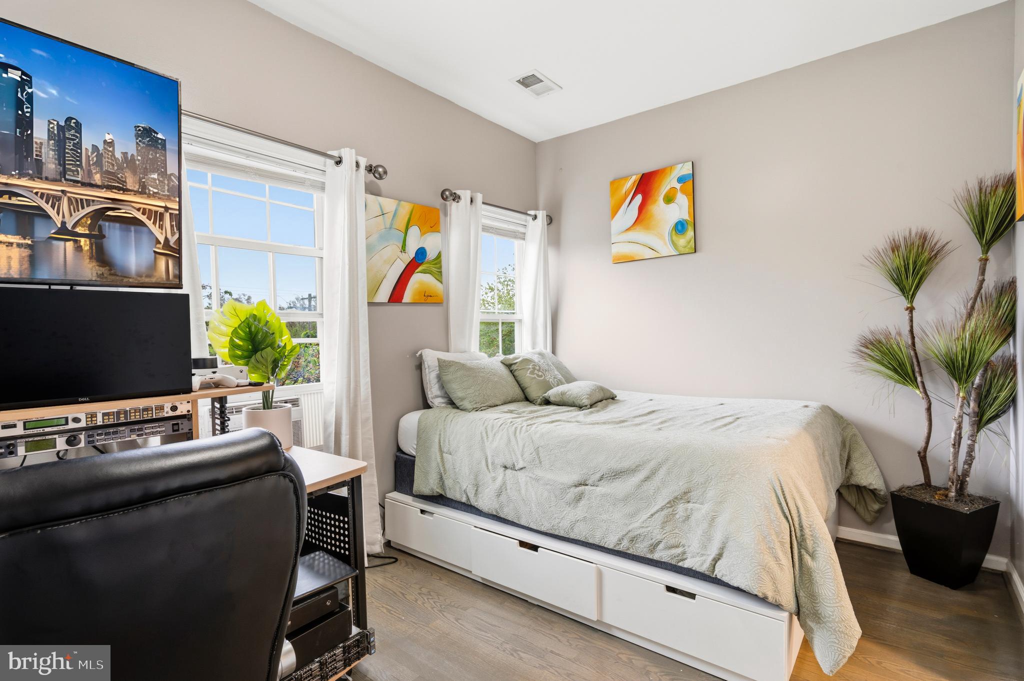 4285 South Capitol Street Southwest Washington, DC 20032 - Photo 16 of 24 a bedroom with a bed and a flat screen tv