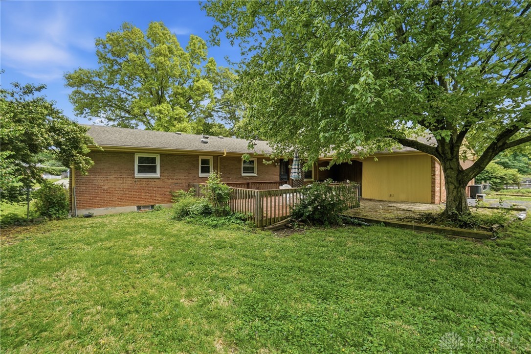 6119 Flemington Road Dayton, OH 45459 - Photo 58 of 76 This residence features a spacious backyard with a charming deck, perfect for outdoor enjoyment.