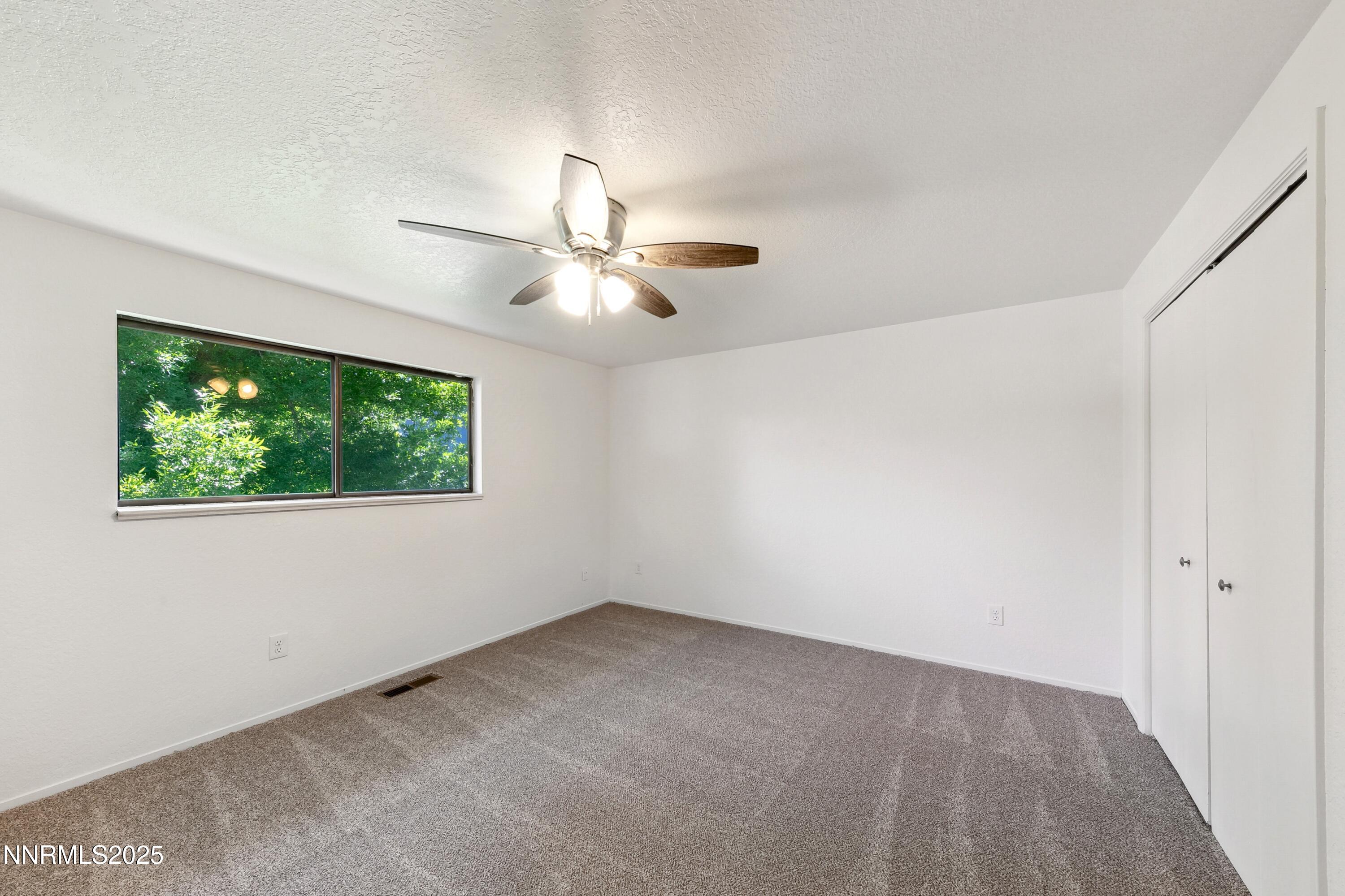 718 Travis Drive, Unit D Carson City, NV 89701 - Photo 18 of 19 an empty room with a window