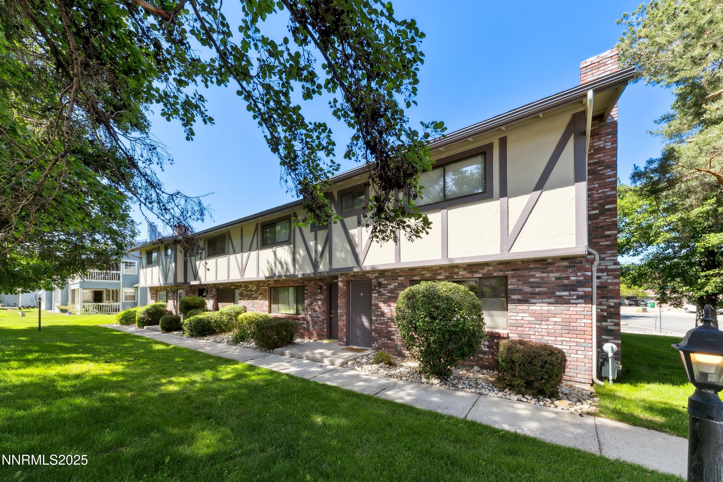 718 Travis Drive, Unit D Carson City, NV 89701 - Photo 2 of 19 a view of a house with a yard