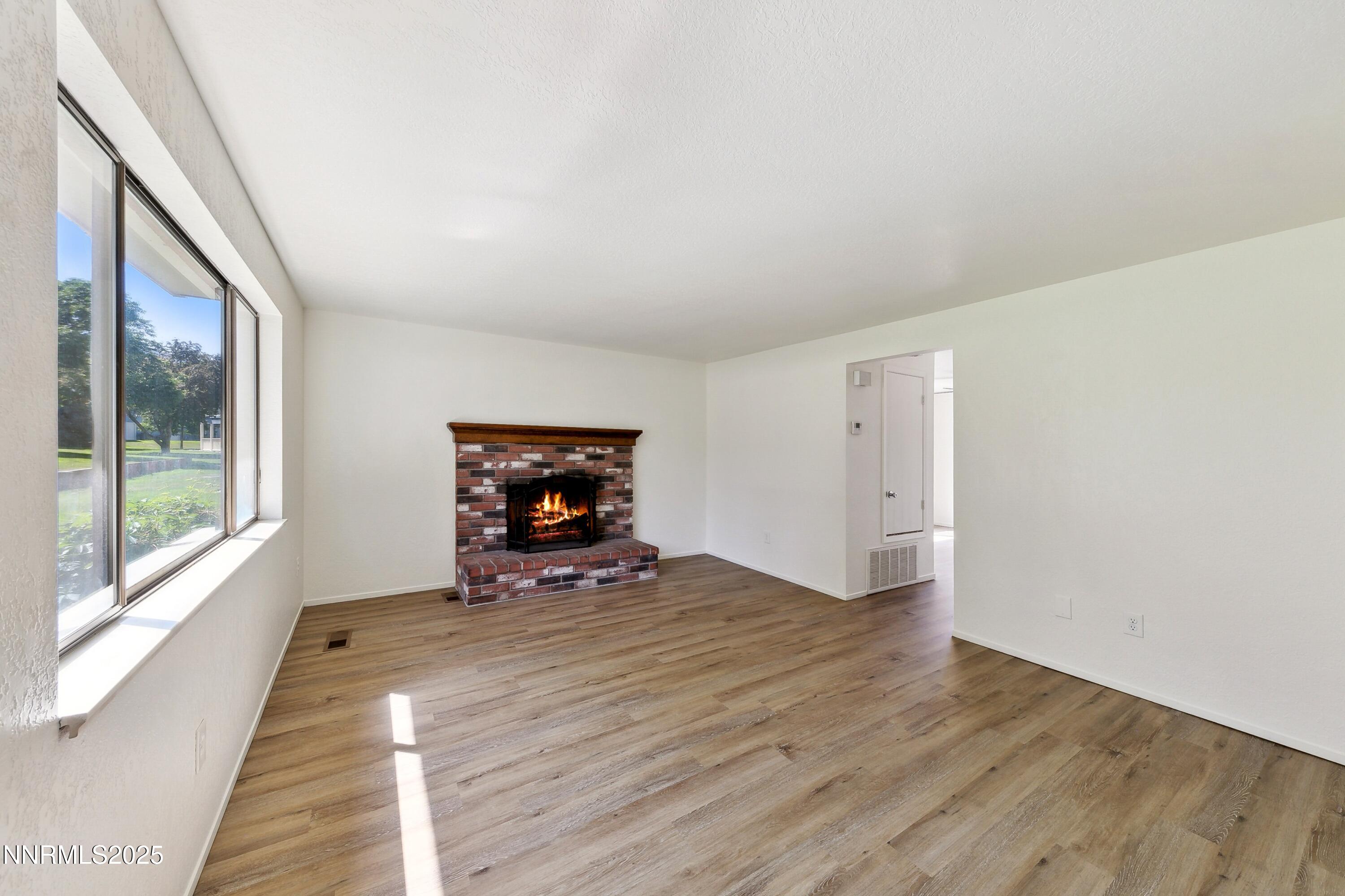 718 Travis Drive, Unit D Carson City, NV 89701 - Photo 3 of 19 a view of a livingroom with wooden floor and window