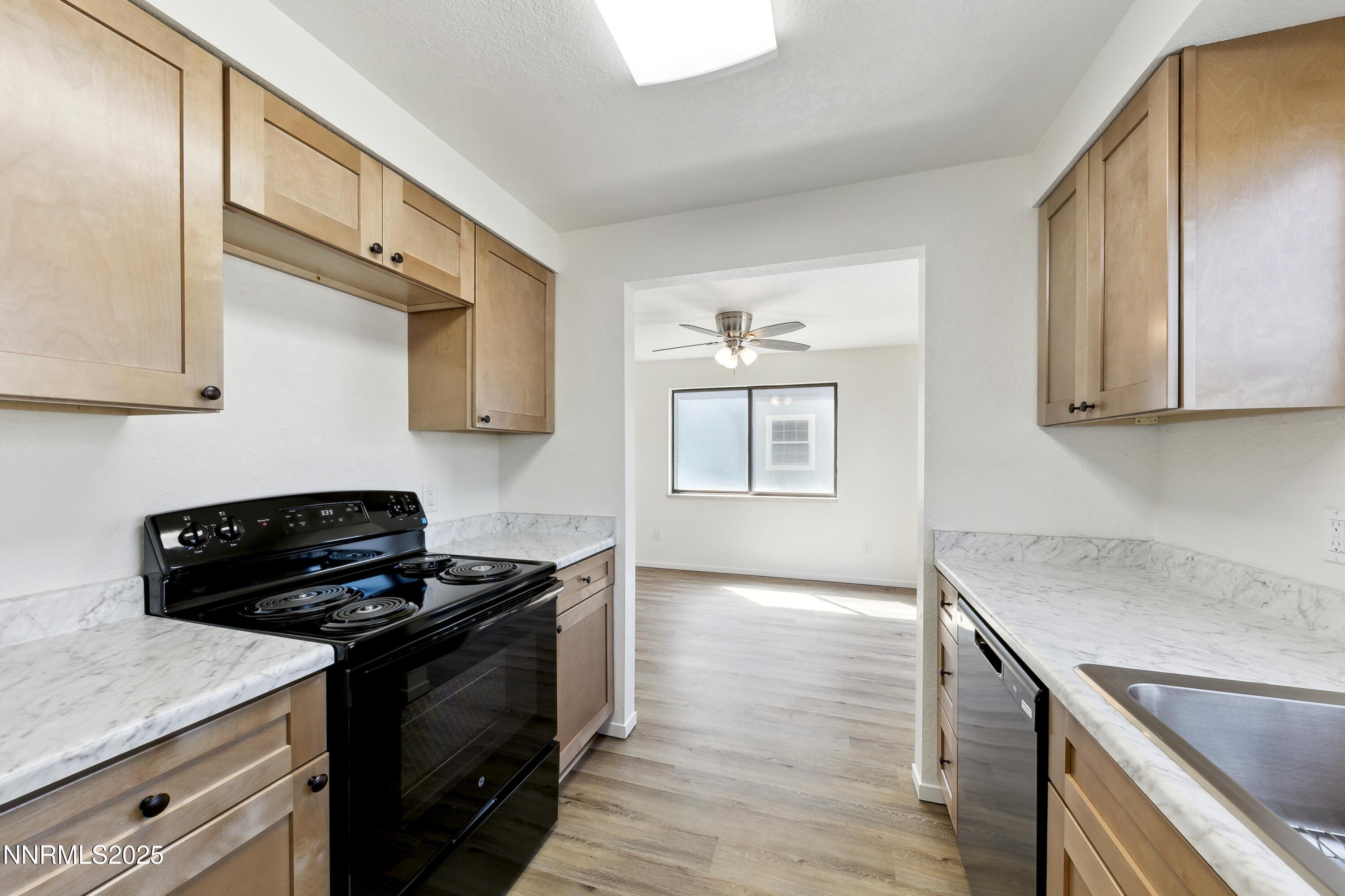 718 Travis Drive, Unit D Carson City, NV 89701 - Photo 10 of 19 a kitchen with stainless steel appliances granite countertop a stove a sink and a microwave