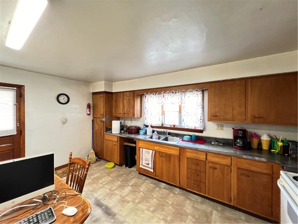 442 East Washington Street Rochester, PA 15074 - Photo 4 of 23 a kitchen with stainless steel appliances granite countertop a sink stove and refrigerator