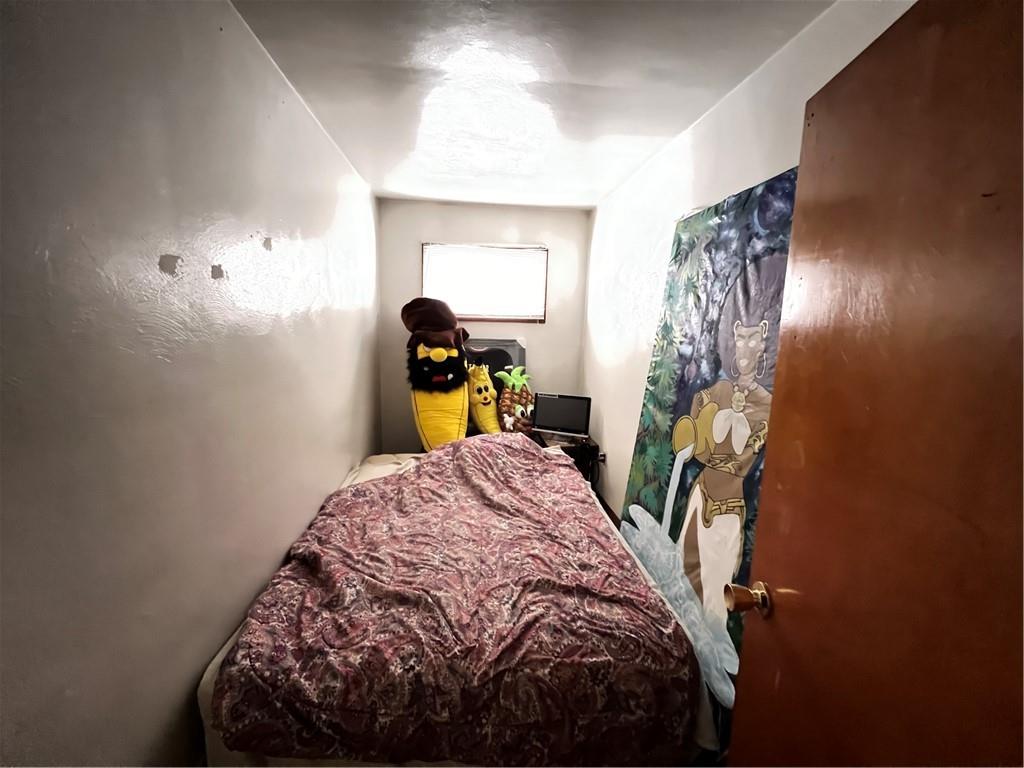 442 East Washington Street Rochester, PA 15074 - Photo 10 of 23 a bed sitting in a bedroom next to a window