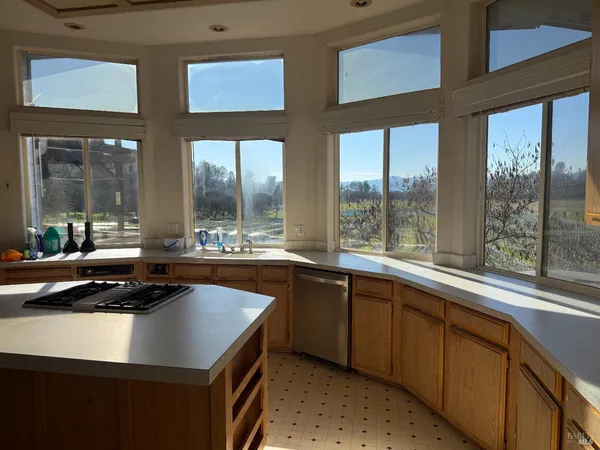 a kitchen with a sink a counter top space and a large window