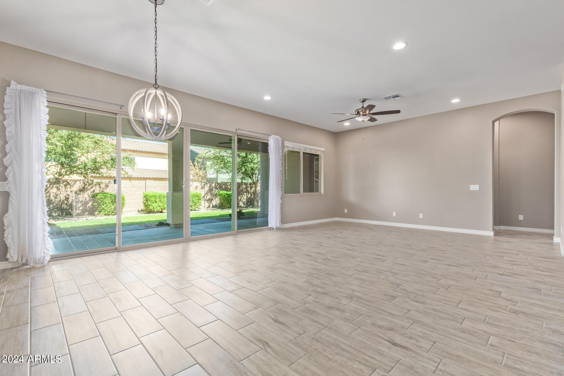 43944 Stonecreek Road Maricopa, AZ 85139 - Photo 16 of 62 a view of empty room with wooden floor and fan