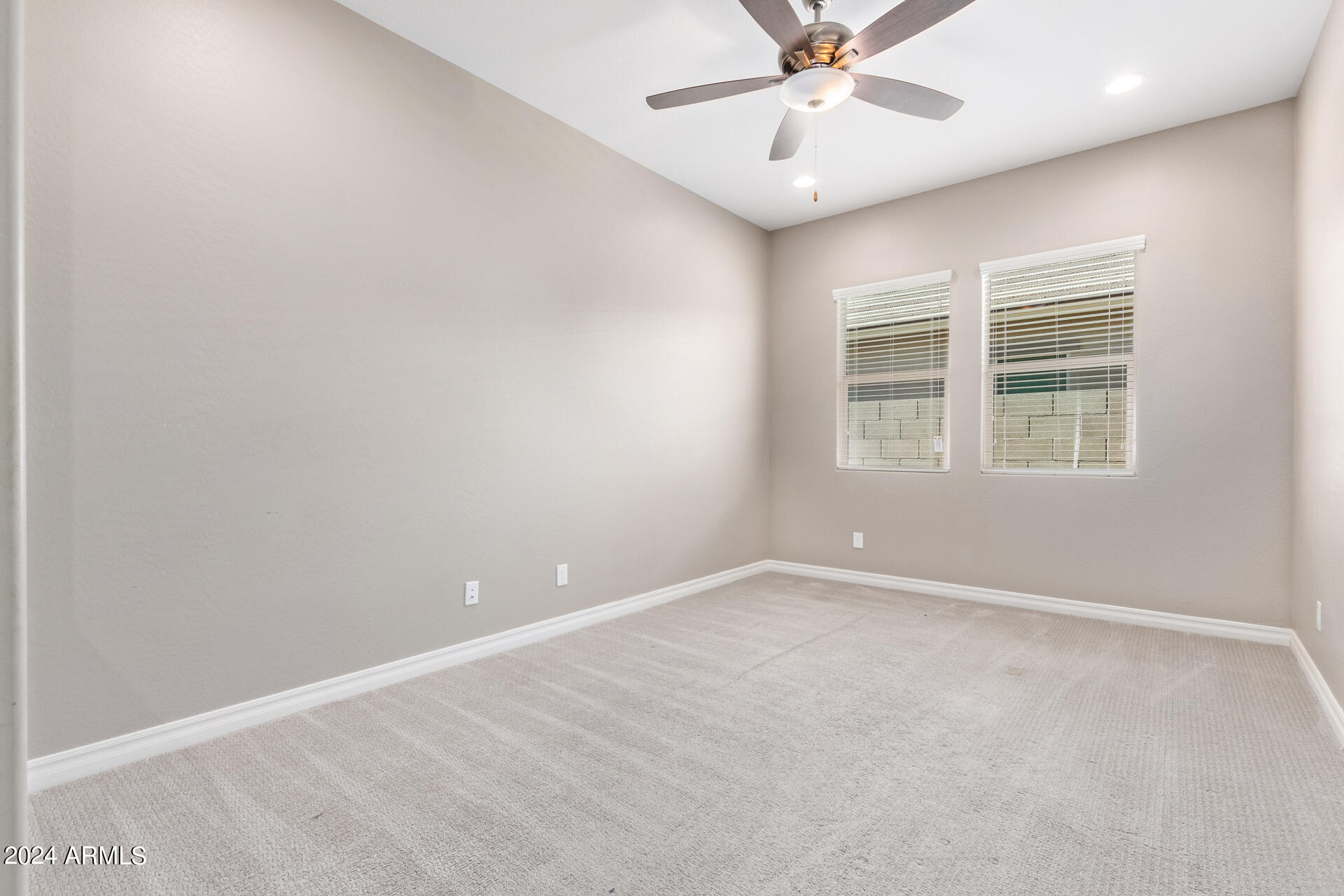 43944 Stonecreek Road Maricopa, AZ 85139 - Photo 17 of 62 an empty room with windows and fan