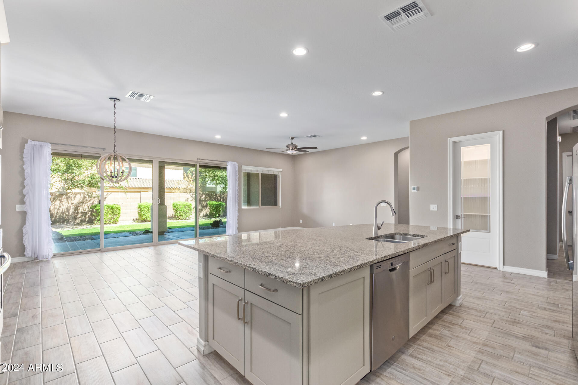 43944 Stonecreek Road Maricopa, AZ 85139 - Photo 20 of 62 a kitchen with granite countertop a sink and a stove