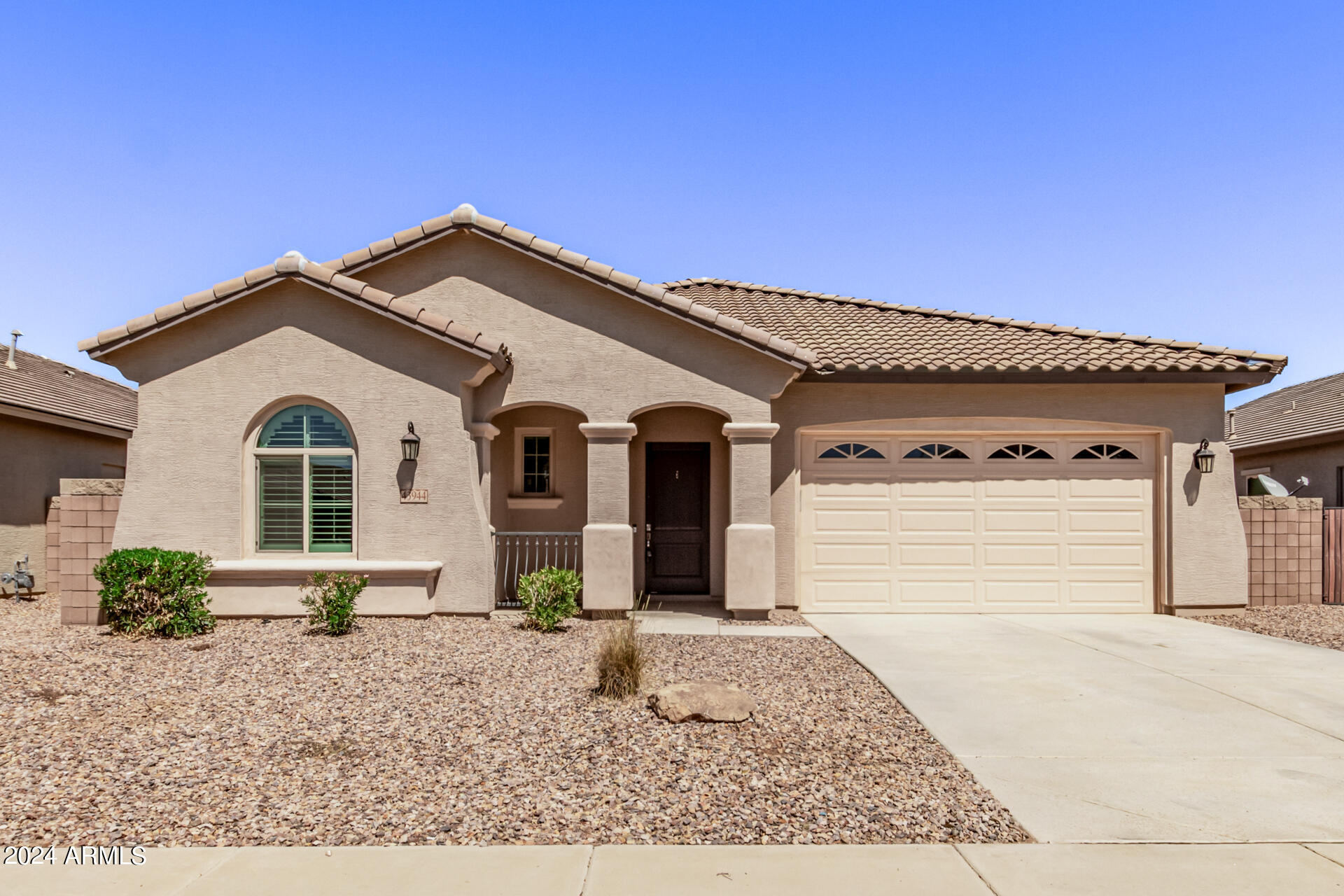 43944 Stonecreek Road Maricopa, AZ 85139 - Photo 2 of 62 a front view of a house with garden