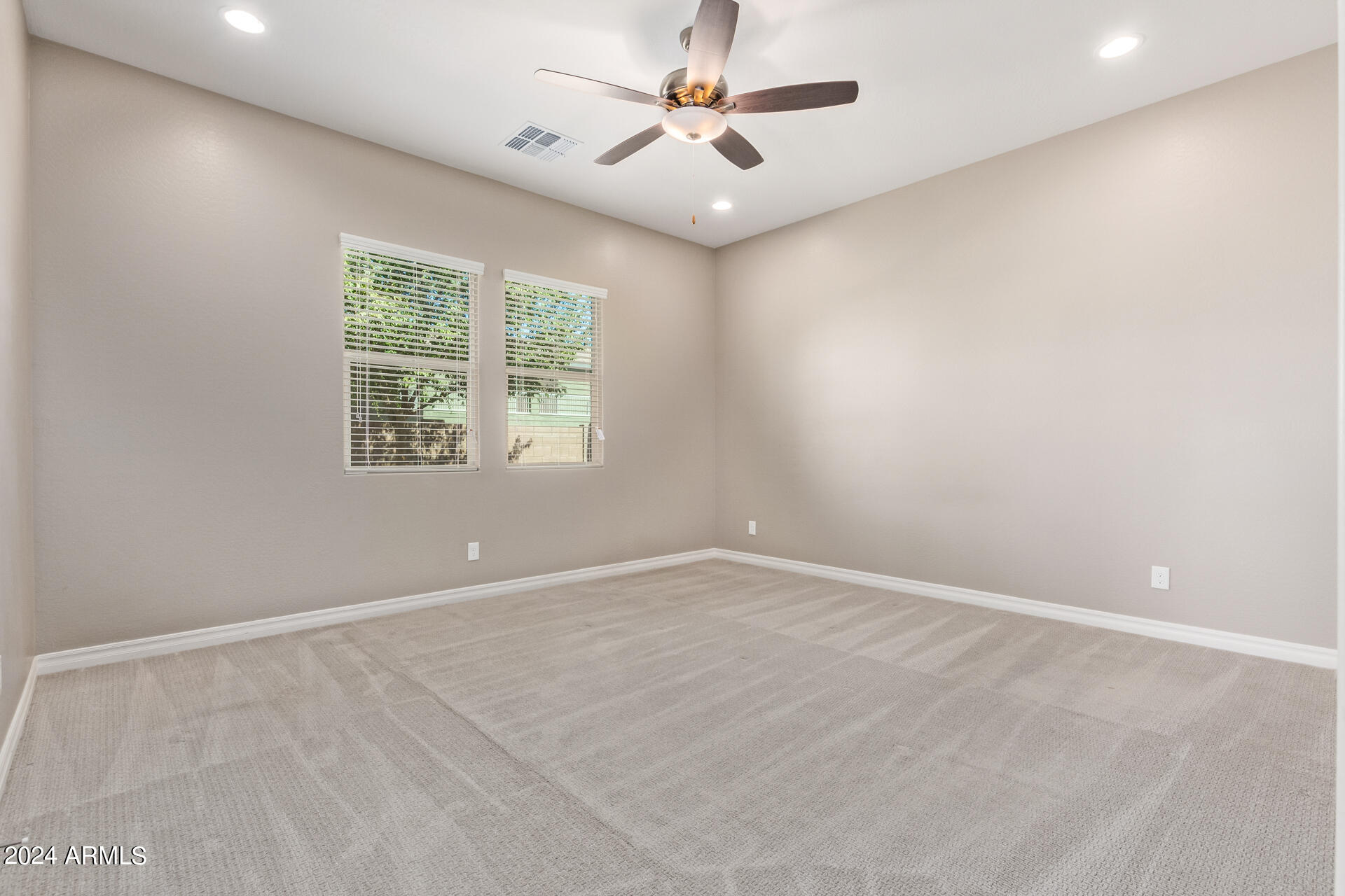 43944 Stonecreek Road Maricopa, AZ 85139 - Photo 22 of 62 an empty room with a window and a fan