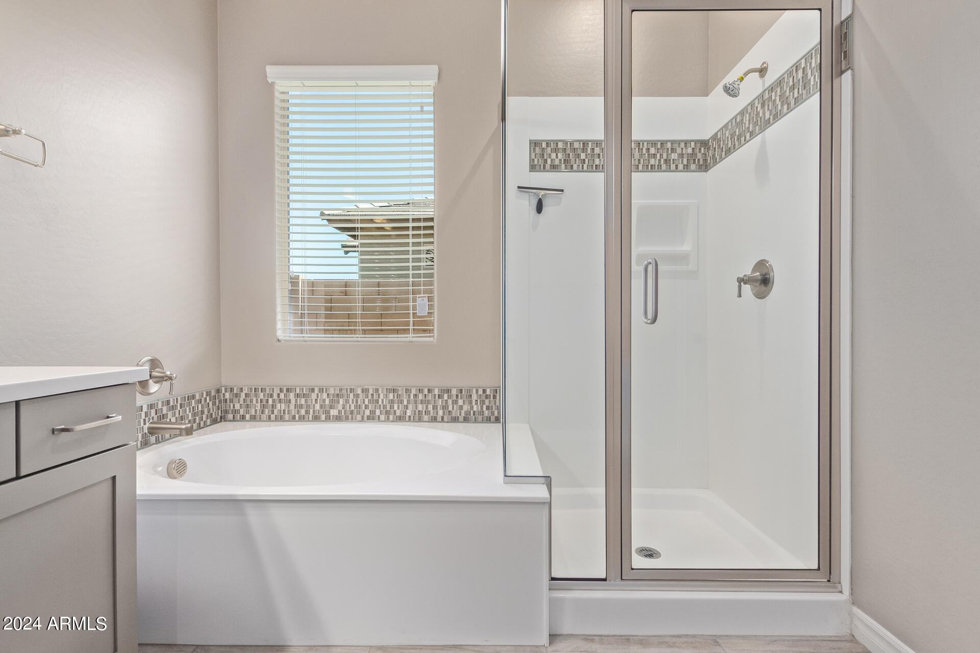43944 Stonecreek Road Maricopa, AZ 85139 - Photo 29 of 62 a bathroom with a bathtub and a shower