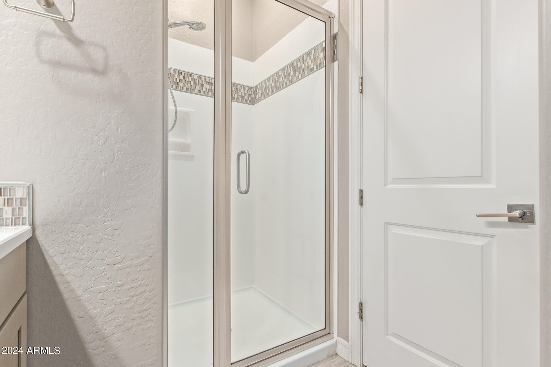 43944 Stonecreek Road Maricopa, AZ 85139 - Photo 34 of 62 a bathroom with a glass shower door
