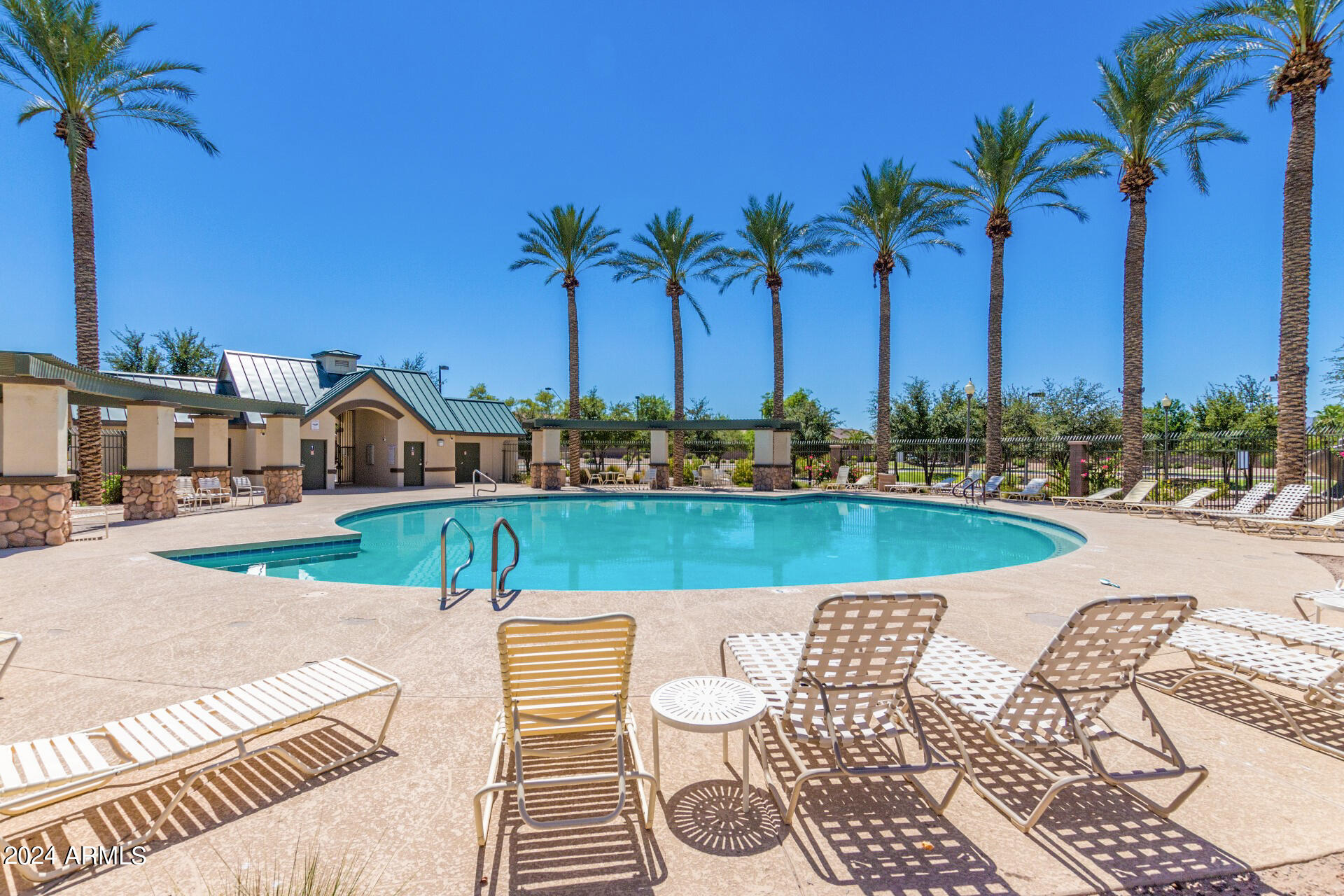 43944 Stonecreek Road Maricopa, AZ 85139 - Photo 49 of 62 a view of a swimming pool with a garden and patio