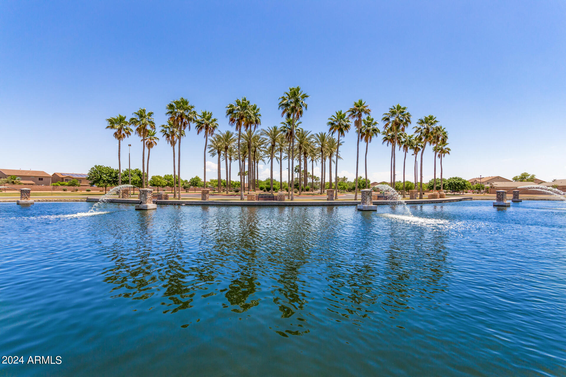 43944 Stonecreek Road Maricopa, AZ 85139 - Photo 56 of 62 a view of a lake with palm trees