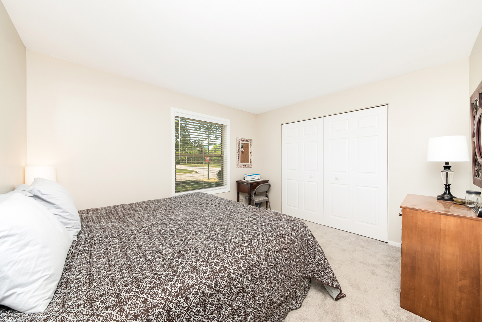1364 McDowell Road, Unit 103 Naperville, IL 60563 - Photo 13 of 19 a bedroom with a bed and a dresser next to a window