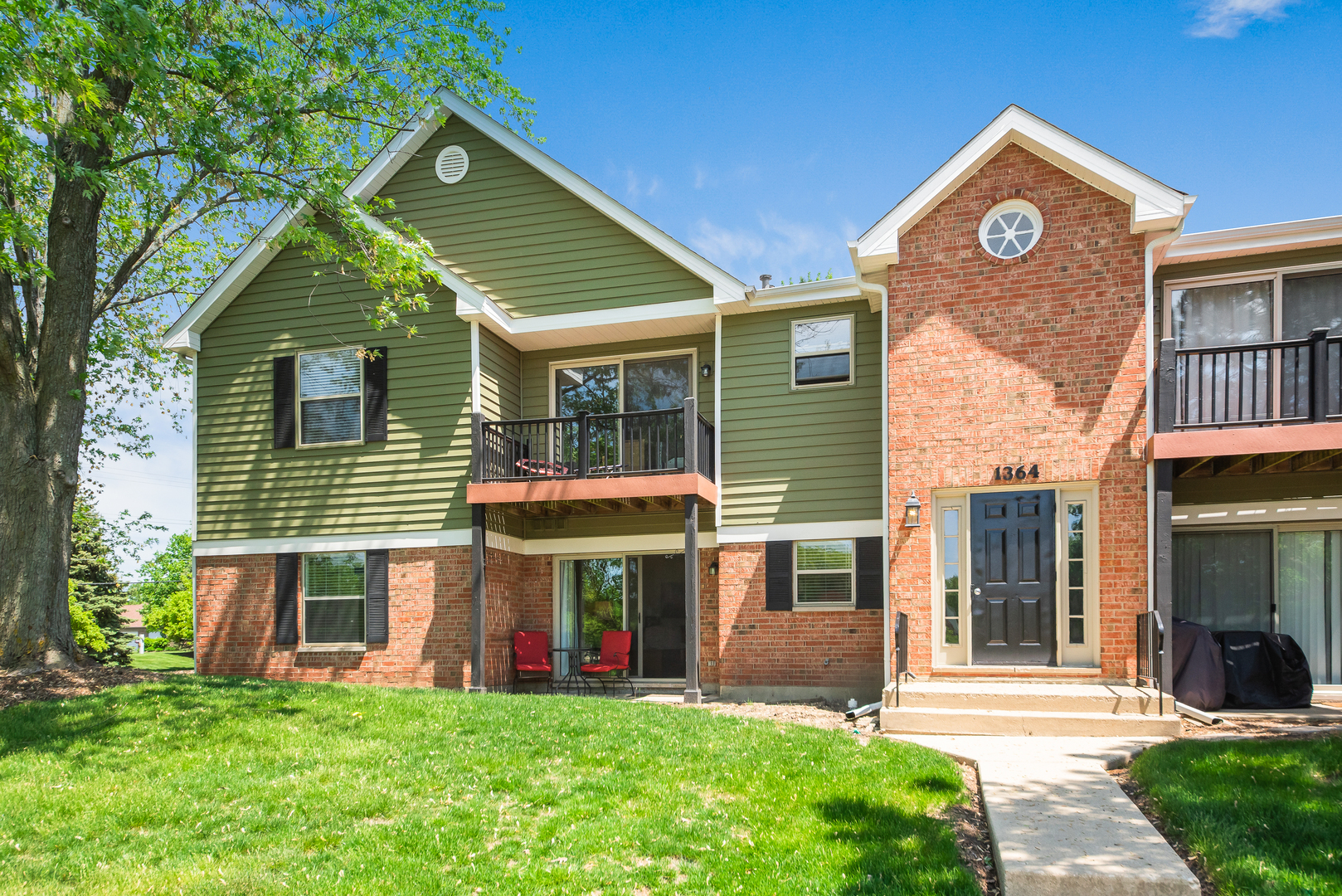 1364 McDowell Road, Unit 103 Naperville, IL 60563 - Photo 2 of 19 a view of a house with a yard and plants