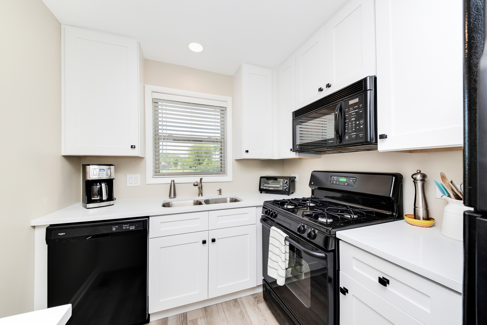 1364 McDowell Road, Unit 103 Naperville, IL 60563 - Photo 3 of 19 a kitchen with a sink stove and white cabinets
