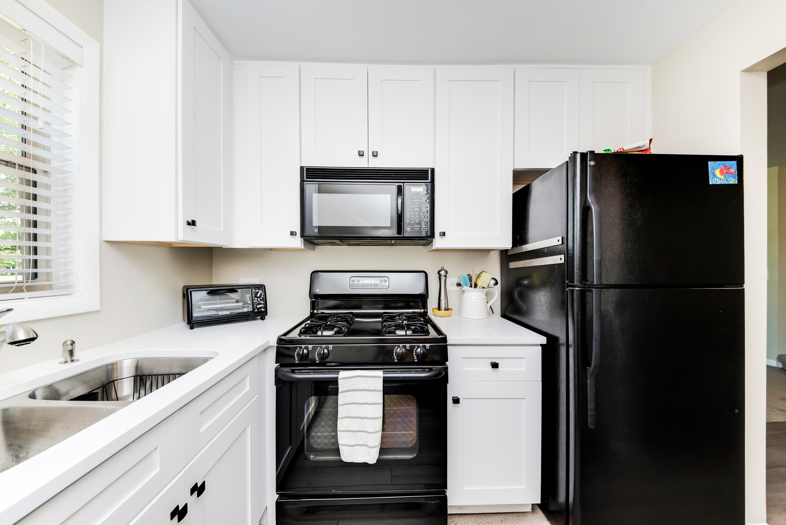 1364 McDowell Road, Unit 103 Naperville, IL 60563 - Photo 4 of 19 a kitchen with a refrigerator stove and sink