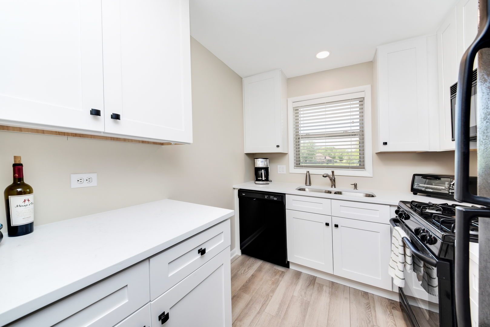 1364 McDowell Road, Unit 103 Naperville, IL 60563 - Photo 5 of 19 a kitchen with a sink a stove and cabinets