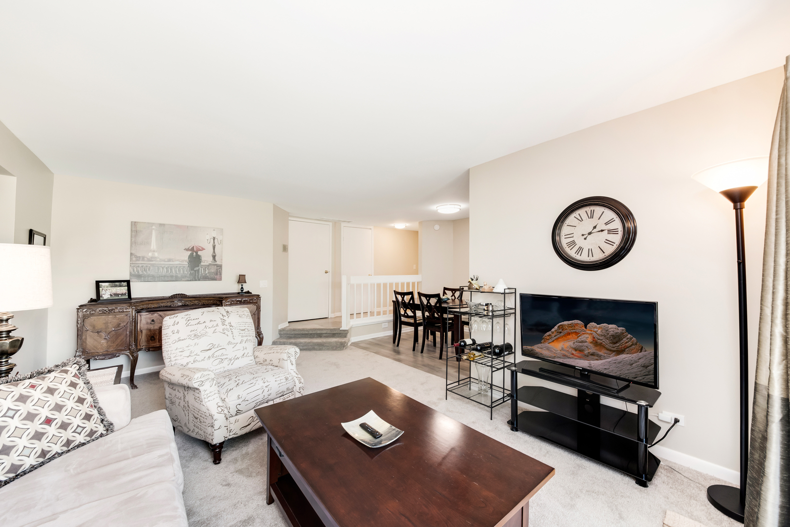 1364 McDowell Road, Unit 103 Naperville, IL 60563 - Photo 8 of 19 a living room with furniture a rug and wall clock