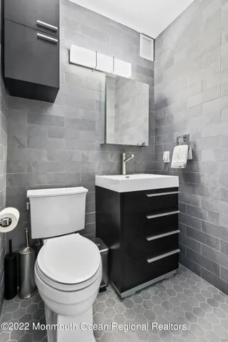 a bedroom with bed and wooden floor