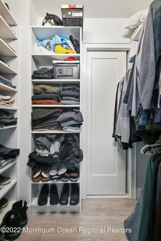 a bathroom with a sink a toilet a mirror and shower