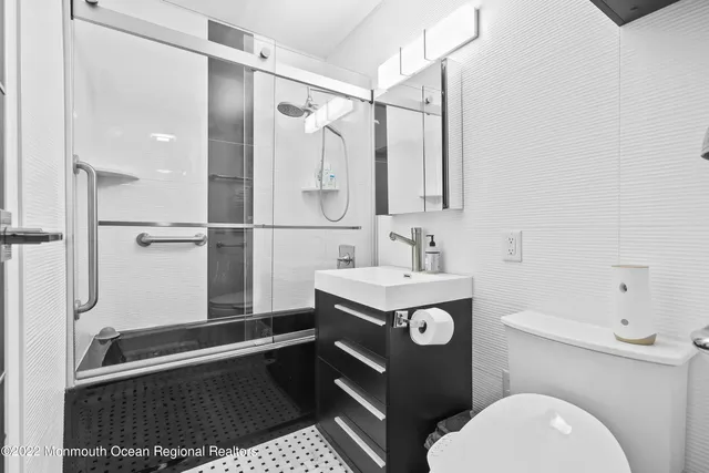 a view of hallway with furniture and a wooden floor