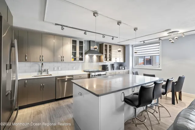 a dining table with chairs and cabinets