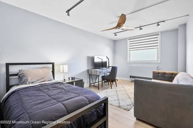 a living room with furniture a rug and a painting