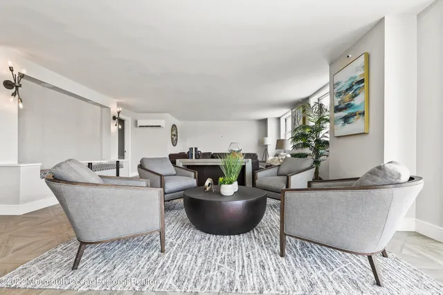 a living room with furniture a rug and a table