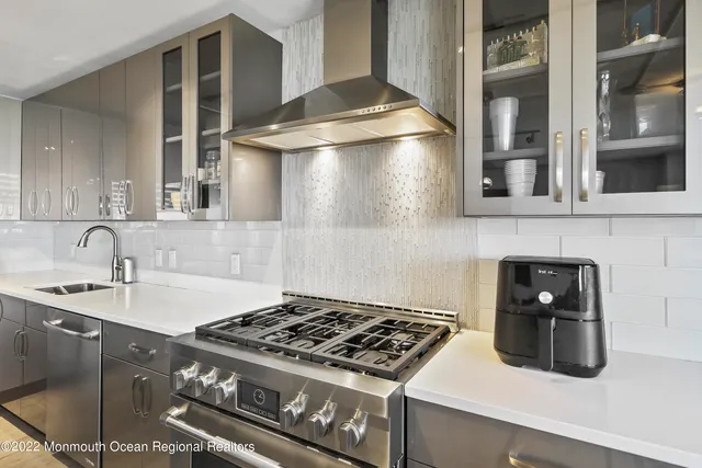 a kitchen with granite countertop a stove and a sink