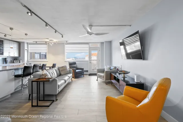 a view of a living room and kitchen with furniture