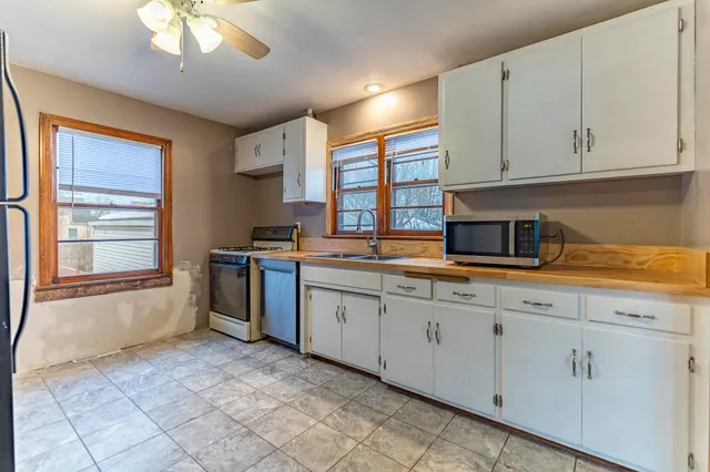 a kitchen with stainless steel appliances granite countertop a sink and cabinets