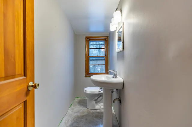 a bathroom with a sink a toilet and mirror