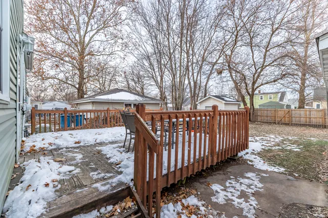 a view of a house with wooden fence next to a road