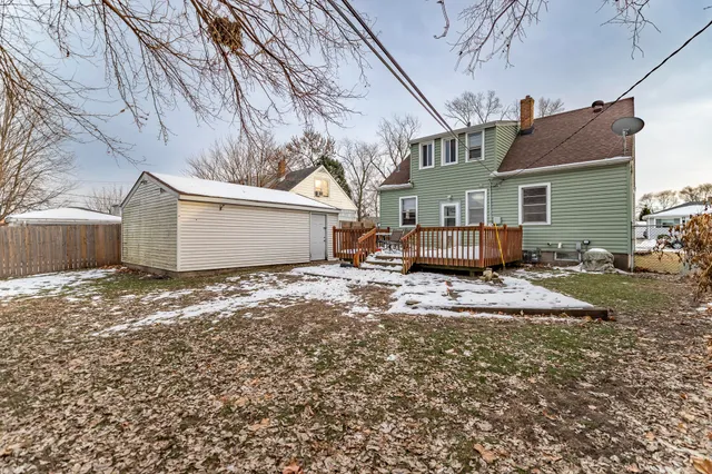a view of a house with a yard covered in snow