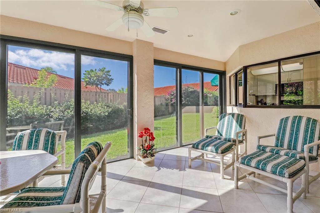 805 Reef Point Circle Naples, FL 34108 - Photo 11 of 33 a living room with furniture and a floor to ceiling window