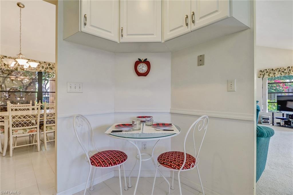 805 Reef Point Circle Naples, FL 34108 - Photo 17 of 33 a table with a dining table and chairs