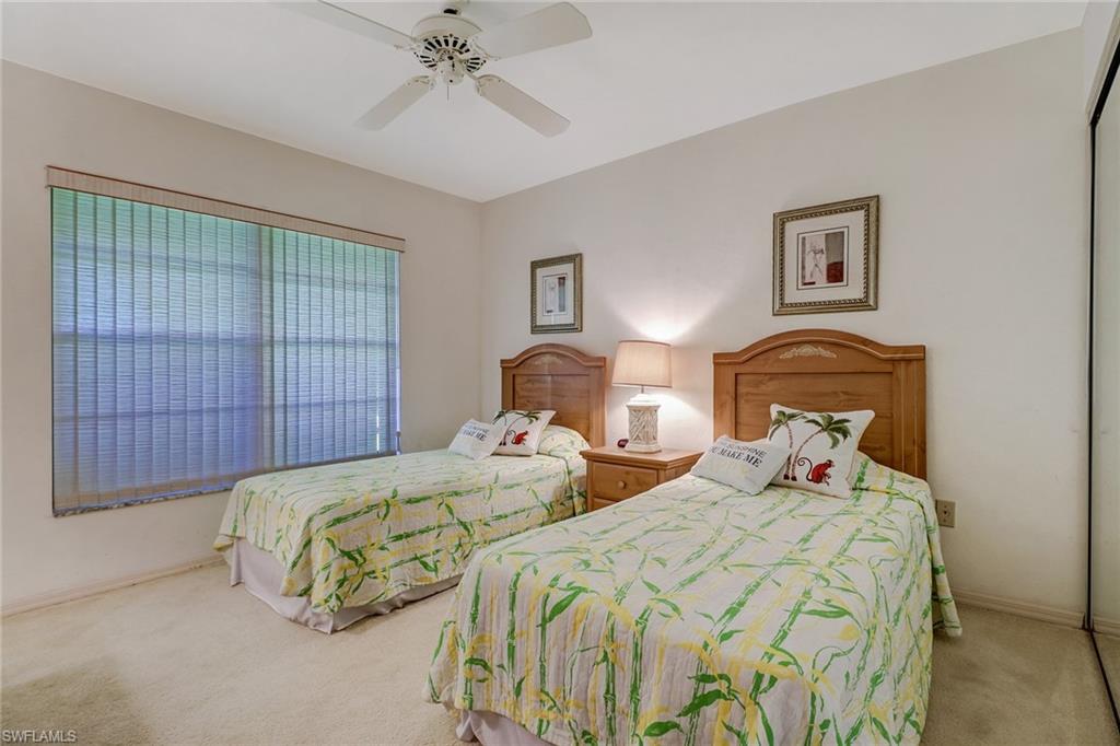 805 Reef Point Circle Naples, FL 34108 - Photo 19 of 33 a bedroom with two beds and painting on the wall