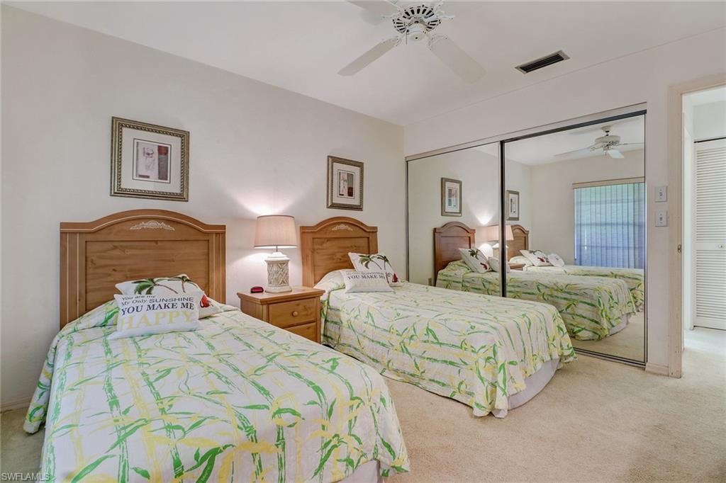805 Reef Point Circle Naples, FL 34108 - Photo 20 of 33 a bedroom with two beds and painting on the wall