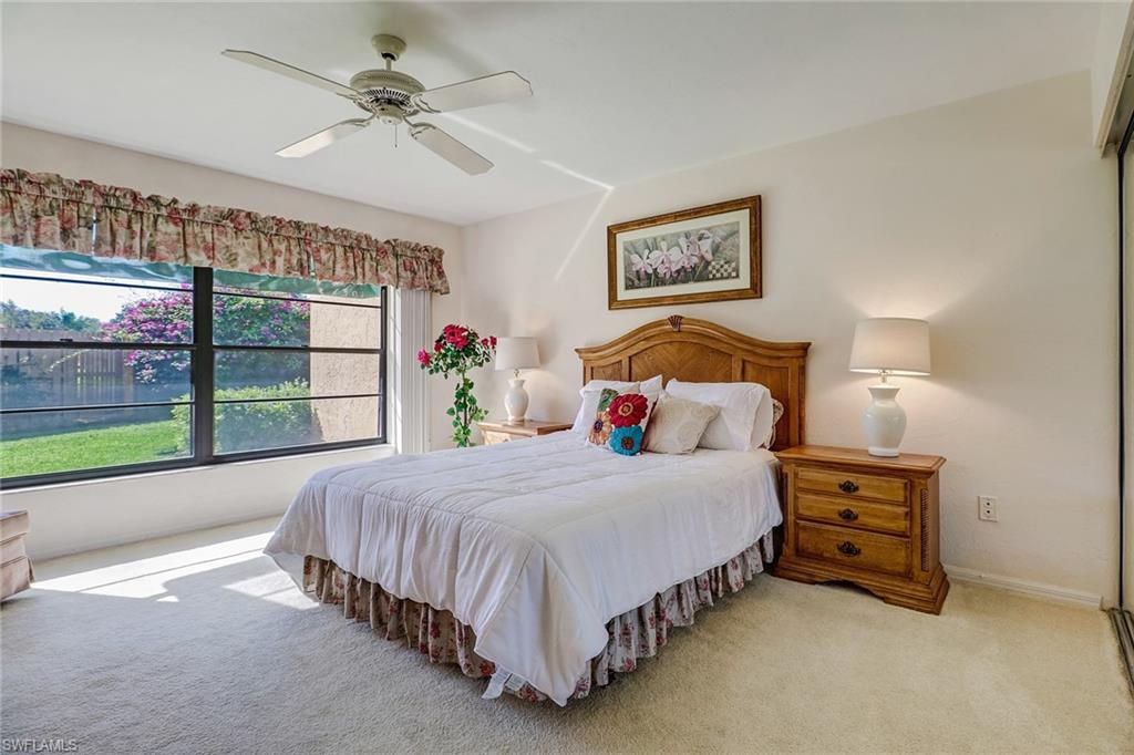 805 Reef Point Circle Naples, FL 34108 - Photo 22 of 33 a bedroom with a bed and a large window