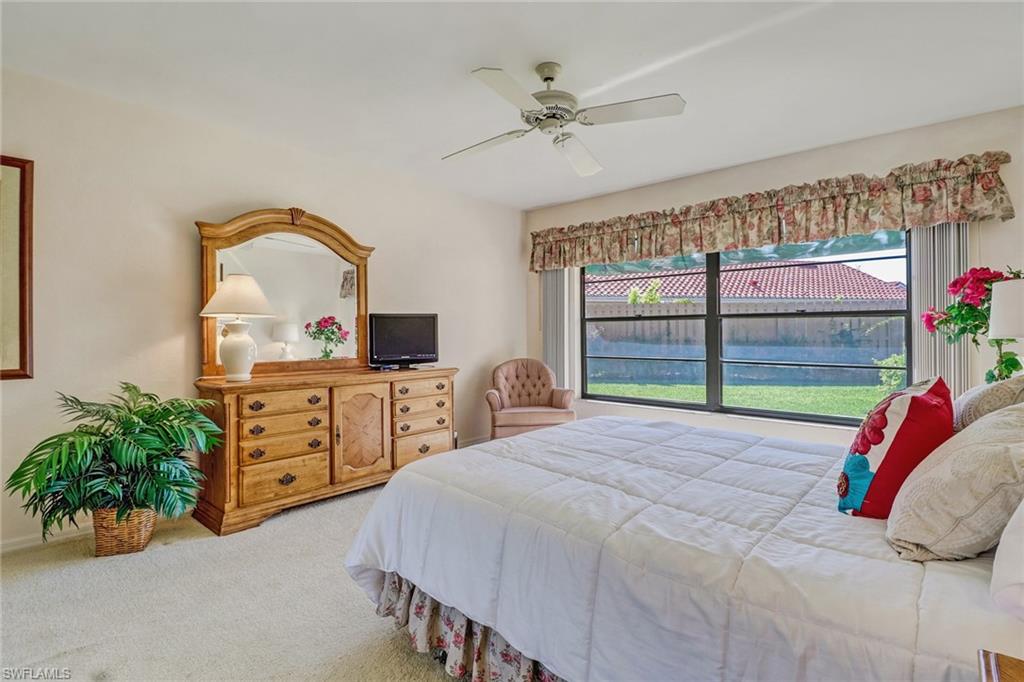 805 Reef Point Circle Naples, FL 34108 - Photo 23 of 33 a bedroom with a bed and a large window