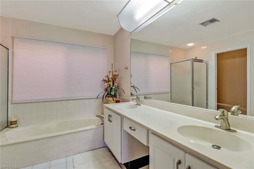 805 Reef Point Circle Naples, FL 34108 - Photo 24 of 33 a bathroom with a tub sink and mirror