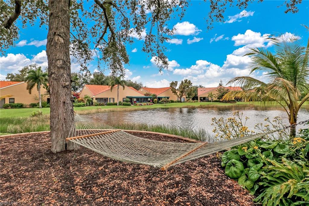 805 Reef Point Circle Naples, FL 34108 - Photo 26 of 33 a view of a lake with a building in the background