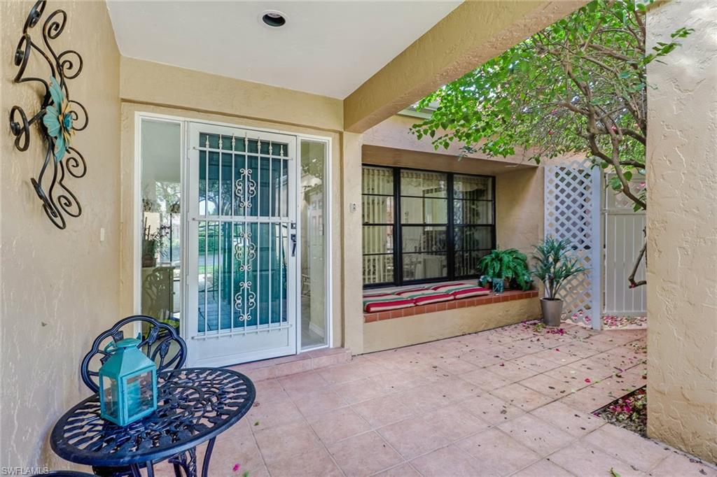 805 Reef Point Circle Naples, FL 34108 - Photo 3 of 33 a view of porch with a bench and potted plant
