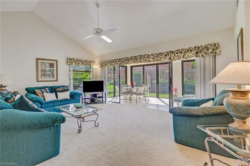 805 Reef Point Circle Naples, FL 34108 - Photo 5 of 33 a living room with furniture and a large window