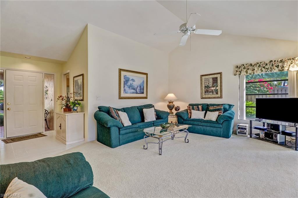 805 Reef Point Circle Naples, FL 34108 - Photo 6 of 33 a living room with furniture and a flat screen tv