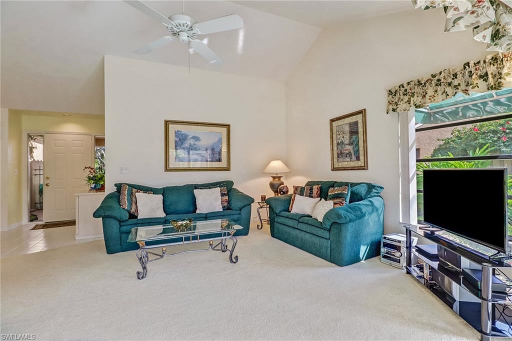 805 Reef Point Circle Naples, FL 34108 - Photo 7 of 33 a living room with furniture and a flat screen tv